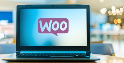  Laptop computer displaying logo of WooCommerce,